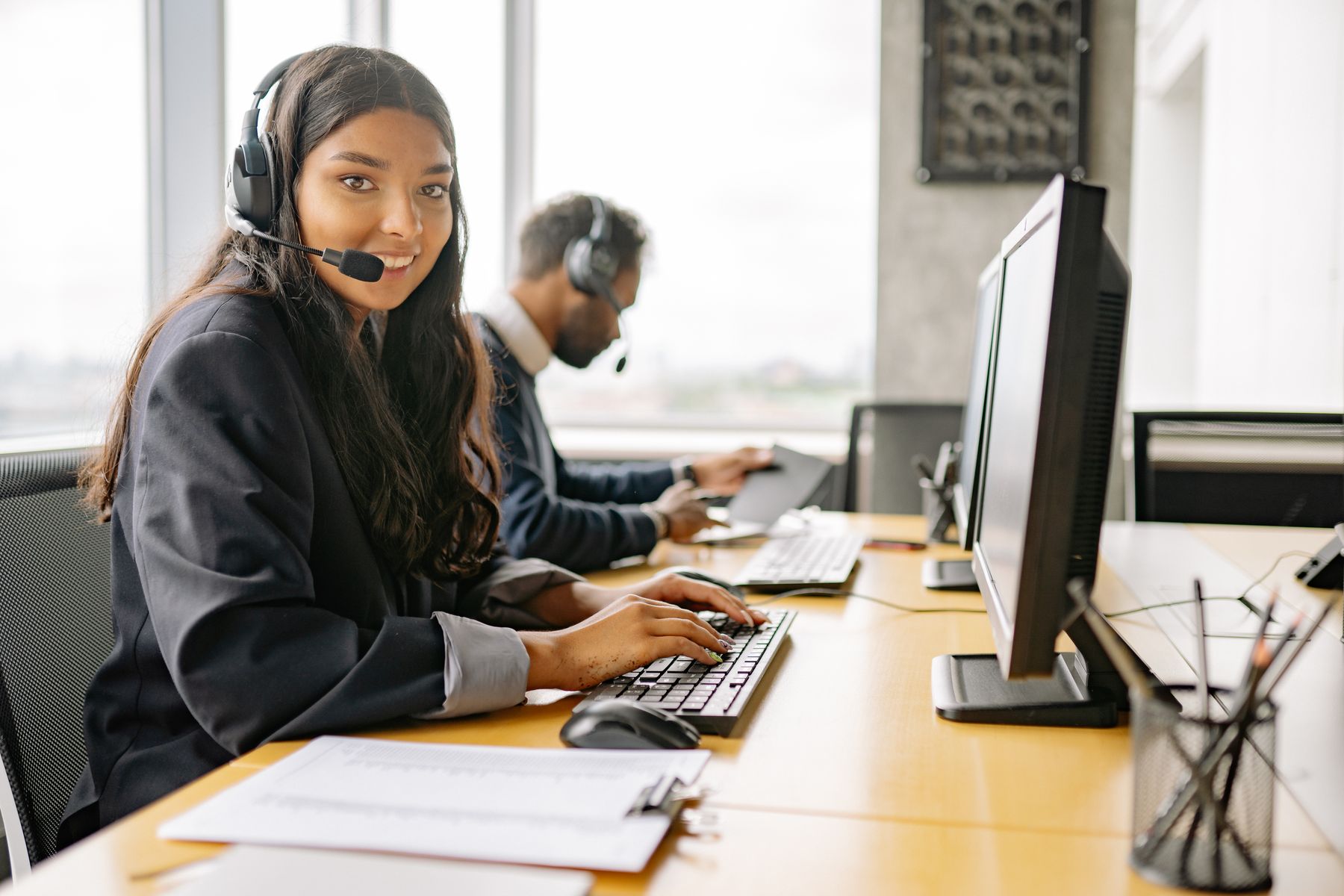 Support specialist reviewing an application at her desk